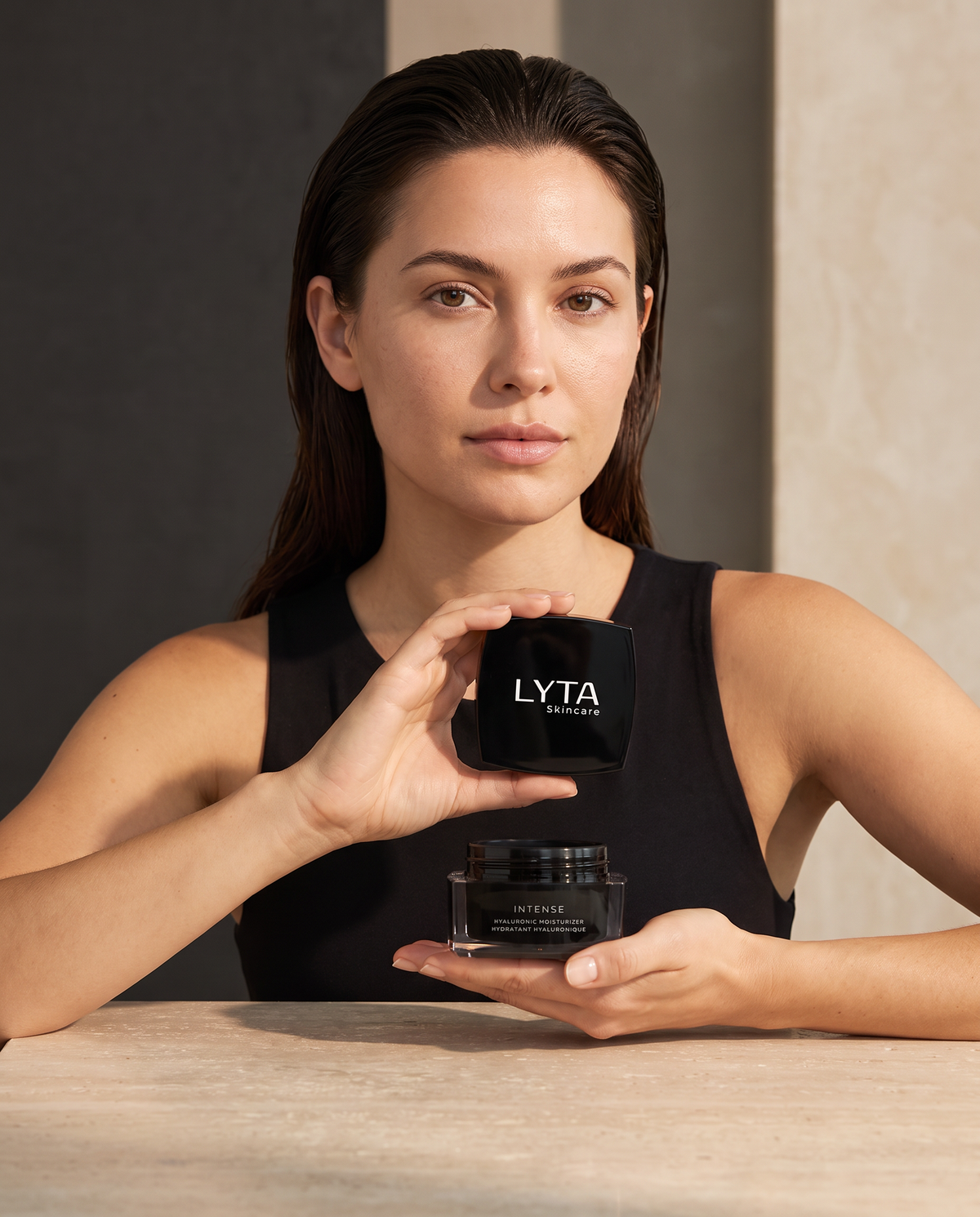 LYTA Hyaluronic Moisturizer, model holding the actual jar and branded lid